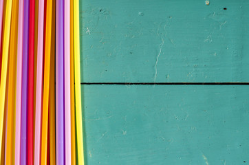 Colorful drinking straws on vibrant table top