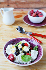 fresh cheese with berries in a bowl