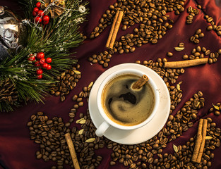 A christmas cup of coffee on a red table