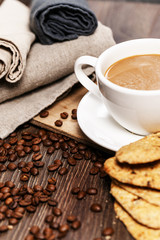 A cup of coffee with biscuits
