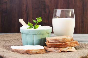Pretty bowl with cream and a glass of milk