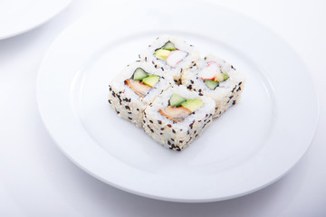 A round plate with four same sushi pieces