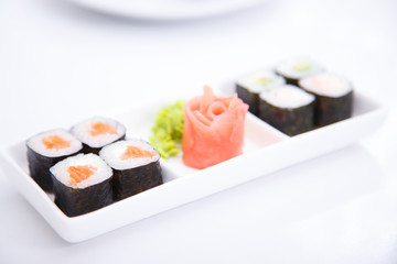 Eight sushi with salmon and different ingredients
