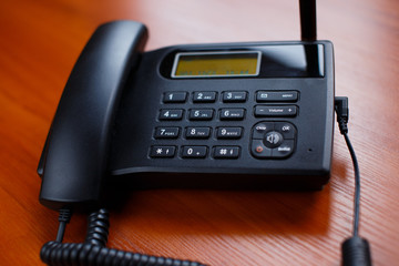 A business phone with a cord