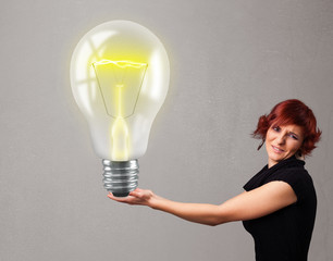 Beautiful lady holding realistic 3d light bulb
