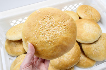 Woman holding bun in hand