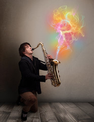 Attractive musician playing on saxophone with colorful abstract