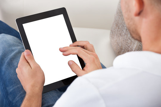Man using his fingers to navigate on a tablet-pc
