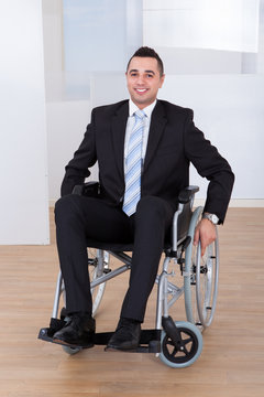 Disabled Businessman In Wheelchair At Office