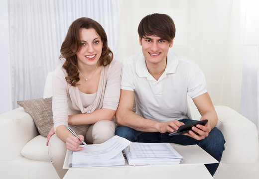 Young couple calculating budget