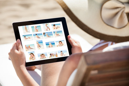 Woman Looking At Her Pictures On Digital Tablet