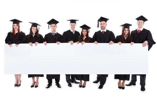 Graduate students holding empty banner