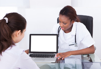 Dentist Showing Laptop Patient