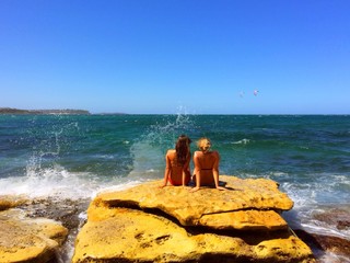 girls watching the ocean