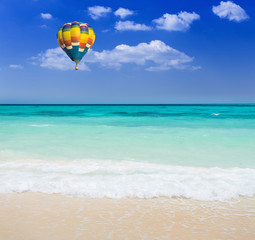 Colorful hot air balloon over the beach