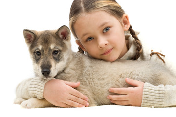 child hugging a puppy