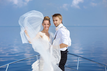 Happy bride and groom on a yacht