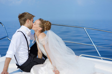 Happy bride and groom on a yacht