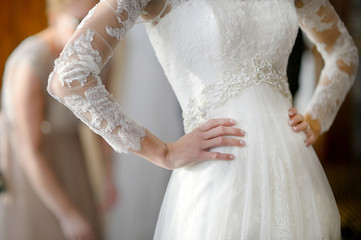 Bride's hands on a wedding dress