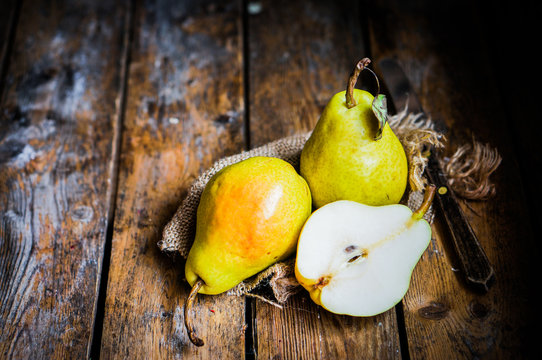 Pears on rustic wooden background