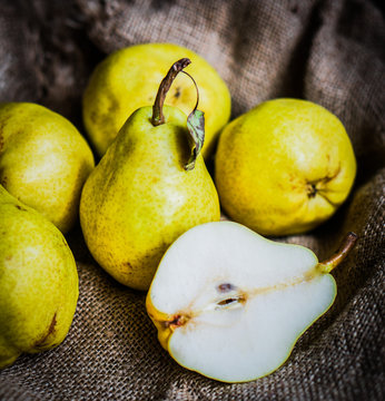 Pears on rustic wooden background