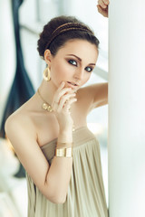 Portrait of beautiful woman in gold dress with arabic make up