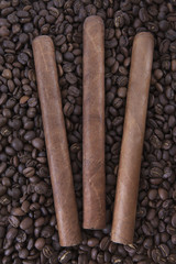 Three cigar on coffee beans background