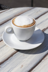 cup of cappuccino on wooden table