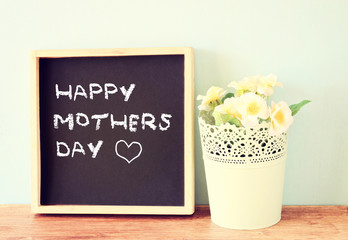 happy mother day written on chalkboard, filtered image.  