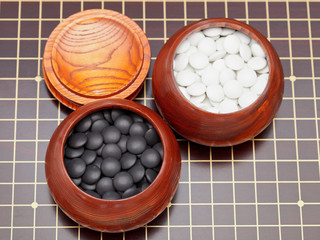 go game stones in wooden bowls
