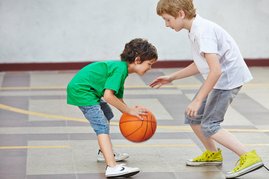 Boys Playing Basketball In School