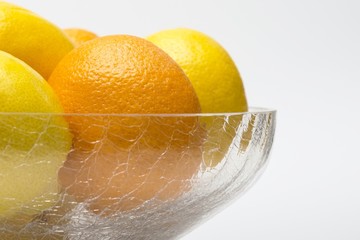 Oranges and lemons in glass bowl