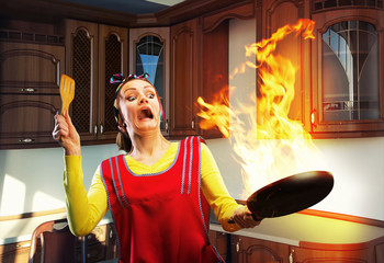 Housewife cooking on the kitchen with big fire