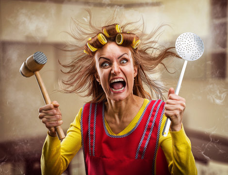 Crazy housewife with hammer on her hand