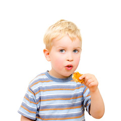 Cute little boy eating delicious cookie isolated on white