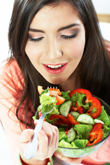 Young woman eat salad. Healthy vegetarian food.