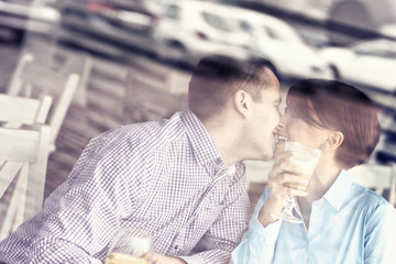 Young couple kissing in a restaurant