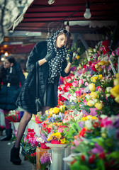 Beautiful brunette woman with gloves at florist shop