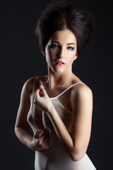 Naklejka premium Sexy model in erotic negligee posing at camera