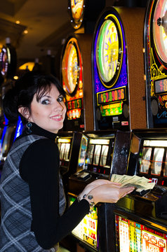 Lucky woman holding money in casino