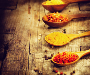 Various spices and herbs over wooden background