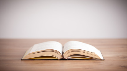 Open book on wooden deck
