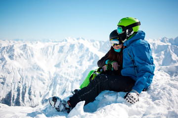 Fototapeta na wymiar Young happy couple in snowy mountains.