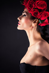 portrait of beauty fashion model with red roses hairstyle