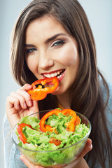 Woman eating green salad . Female model close up face studio is