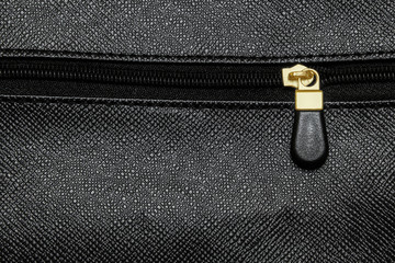 Zip fastener on black leather bag