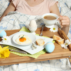 Fototapeta na wymiar Tray with breakfast on a bed