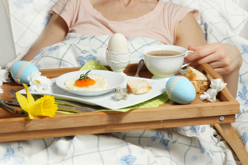 Tray with breakfast on a bed