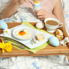 Tray with breakfast on a bed