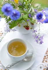 Сup of tea and a bouquet of flowers